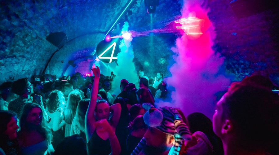Crowd dancing inside Four Music Club in Krakow